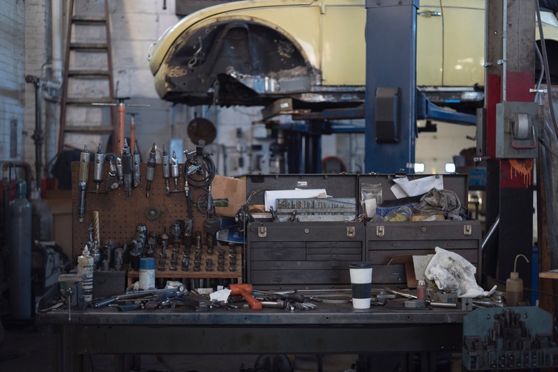 a cup of coffee on a mechanics workbench in a workshop, car mechanics workbench 4k