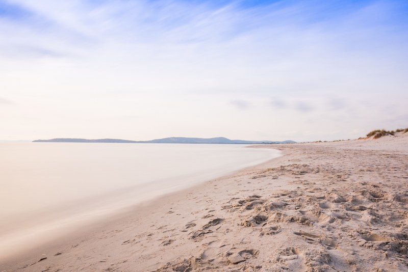 footprints on sand of beach shore of a quiet ocean, footprints in the sand at beach 4k