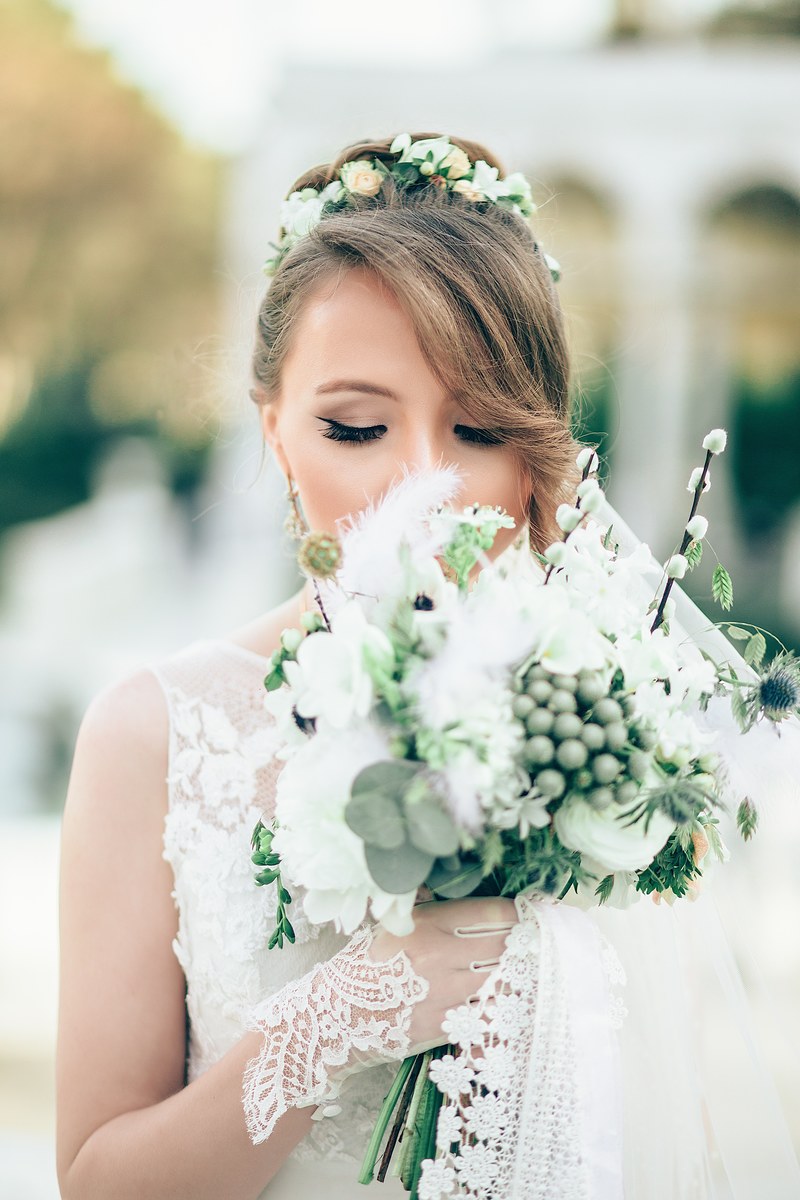 bride smells her unique bouquet in front of blurred background, flowers 4k