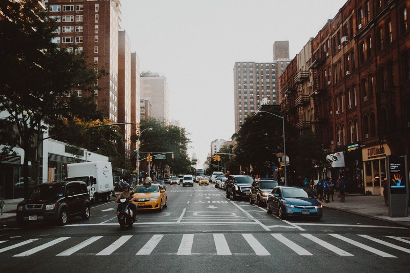 traffic driving through an intersection, _cars and bike at intersection 4k