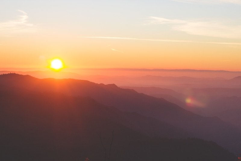 warm view of the sunrise at the summit in the dusk of morning, sunrise over mountains 4k