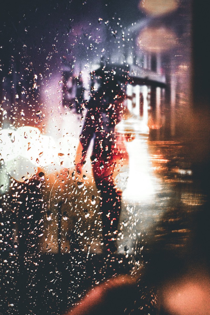 silhouette of a person with an umbrella walking in the rain during night time in melbourne, person rain melbourne 4k