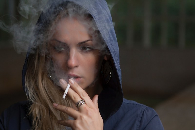 a blonde woman in a blue hoodie smoking a cigarette in lyuberci, woman in hoodie smoking 4k