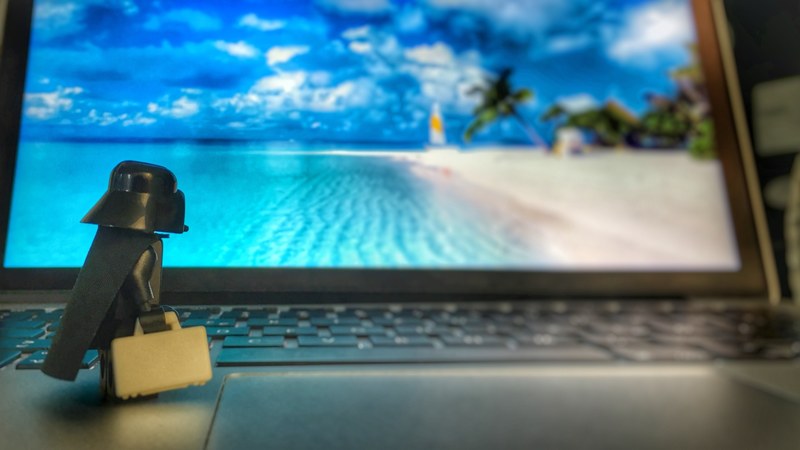 a lego darth vader toy staring at a laptop screen while standing on the keyboard, _lego darth vader on laptop 4k