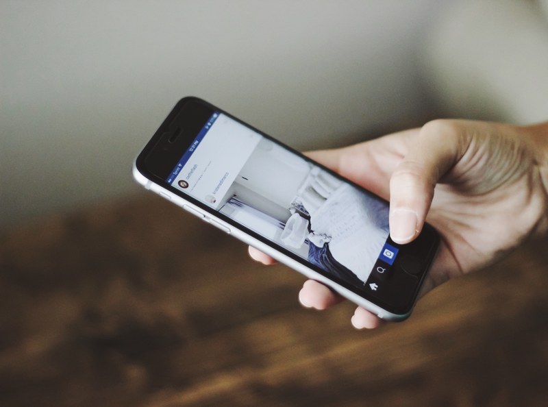 a person browsing instagram on an iphone, browsing instagram 4k