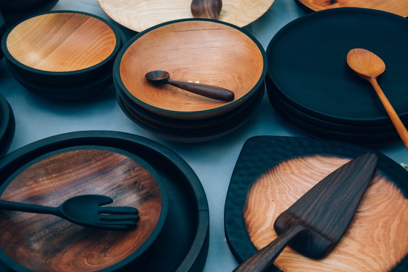 an assortment of wooden bowls plates and cutlery, wooden plates and bowls 4k