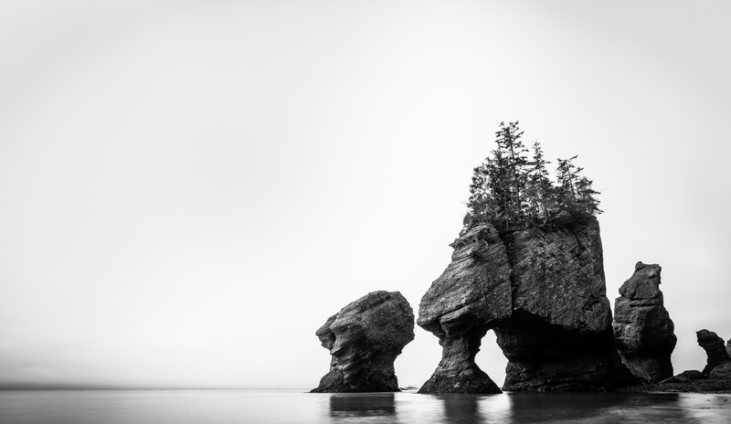 rock jutting rock islet and black and white 4k