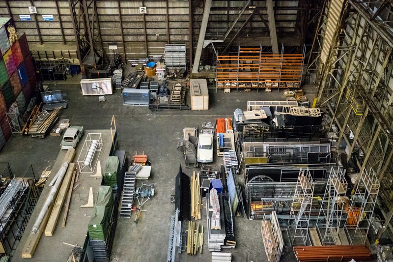 a high view of a large storage area with various racks and containers, industrial storage area 4k
