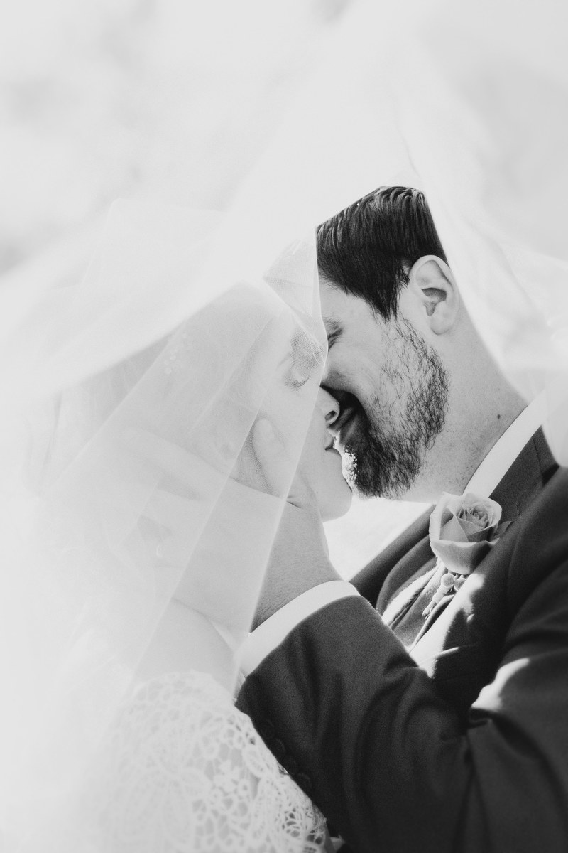 couple kisses in black and white photo under the bridal veil, under the bridal veil 4k