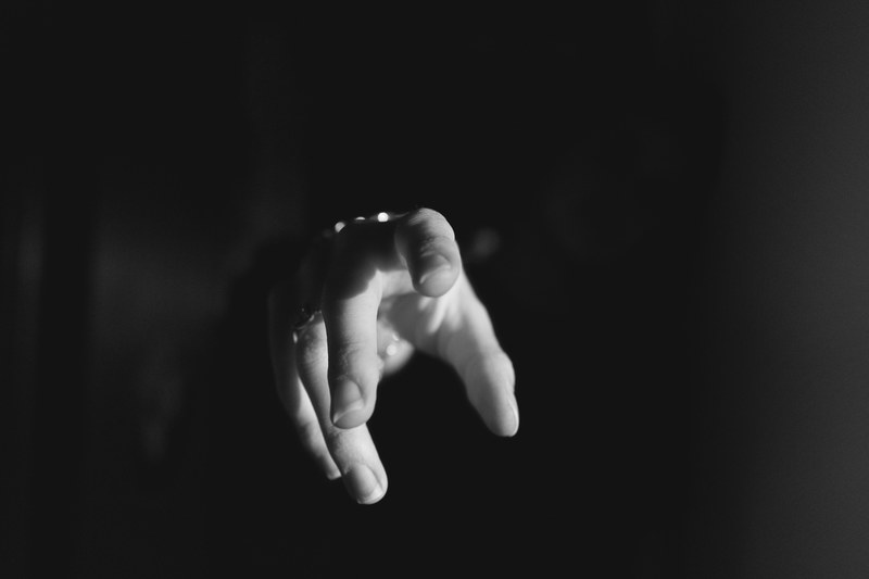 a persons hand reaching for the camera surrounded by darkness, _reaching out 4k