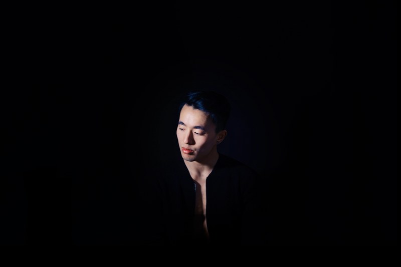 man shadowed in black with only his face lit, hiding from you 4k