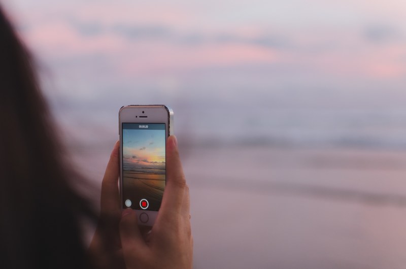 person holding hold and iphone 4k
