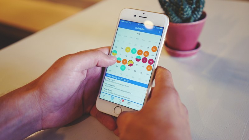 a person looking through the calendar on their smartphone, _smartphone calendar 4k