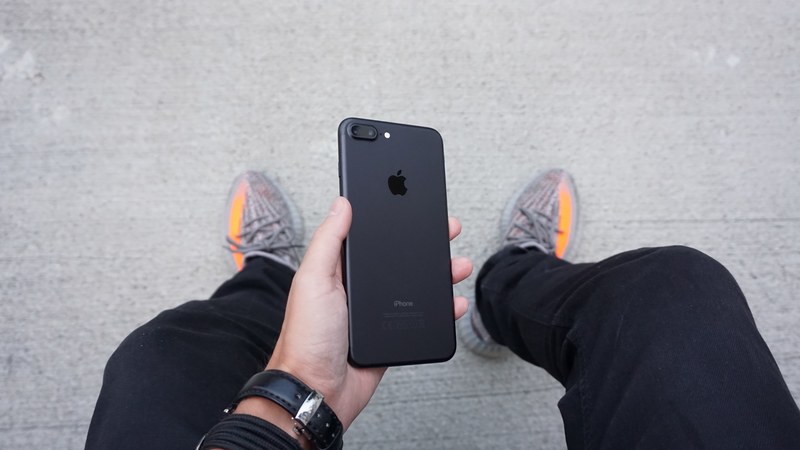 a person holding a black iphone between their legs, _holding black iphone 4k