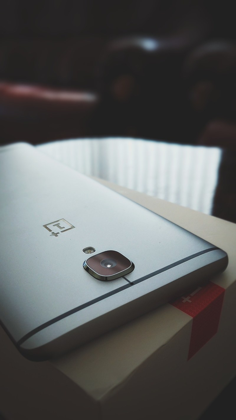 a smartphone lying face down, _back of smartphone 4k