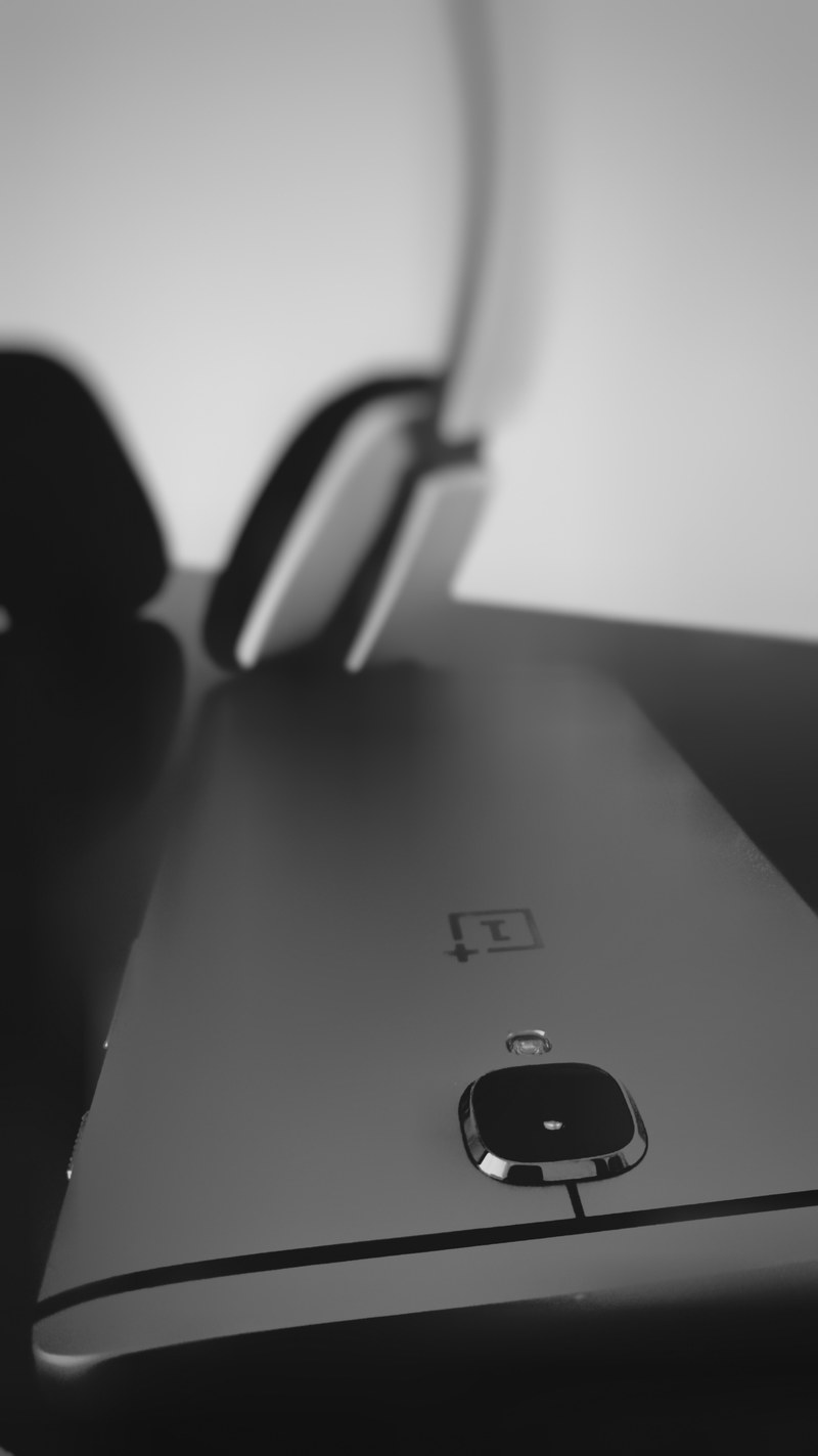 a black smartphone near headphones, _black smartphone by headphones 4k