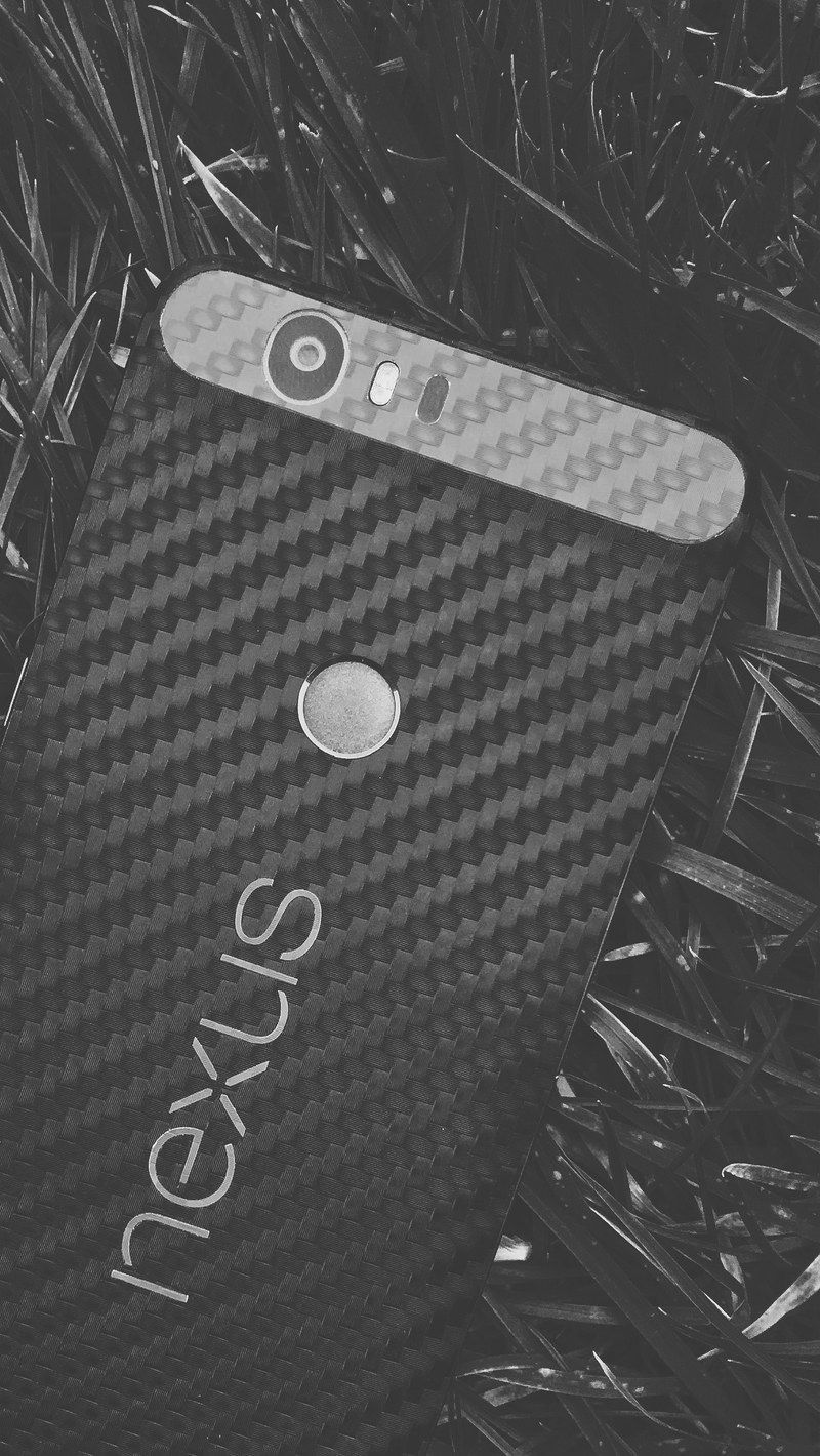 a black nexus phone on the ground, _nexus phone 4k