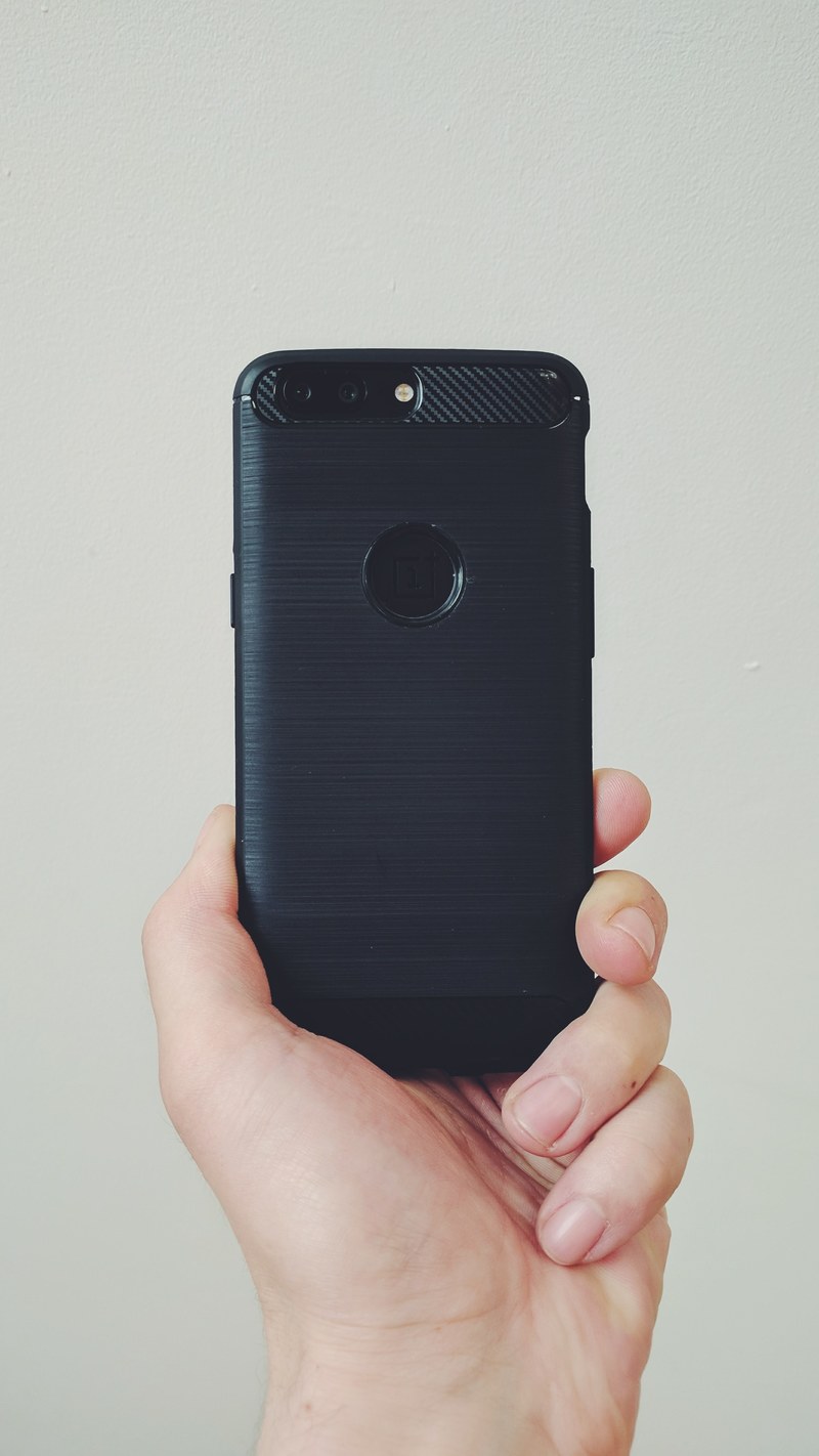 a person holding black phone, _holding black phone 4k