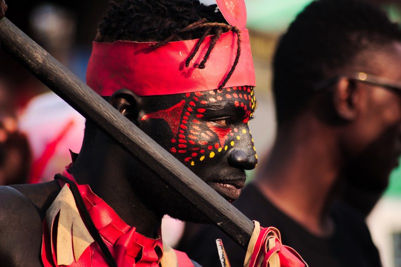 an african american man with face paint holding a stick, _the man 4k