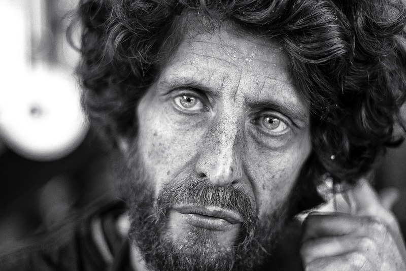a gray portrait view of a wrinkle faced man with beard and lots of hair in london, _jonathan hallam 4k