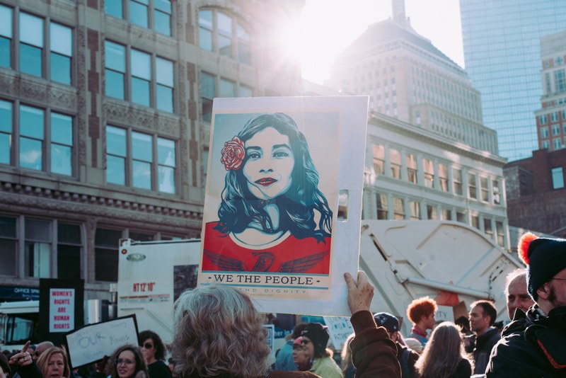 people hold up protest signs at the womens march in boston, we the people 4k