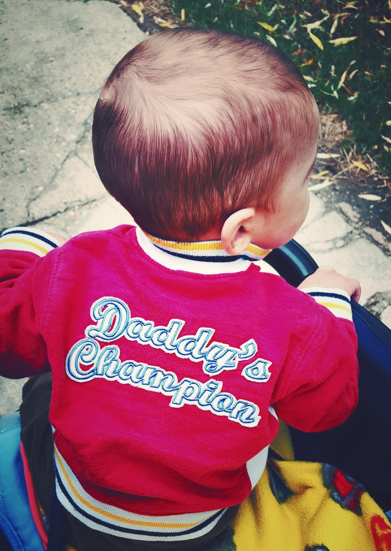 a boy wearing a sweatshirt that says quotdaddys championquot on the back, _daddys champion clothing 4k