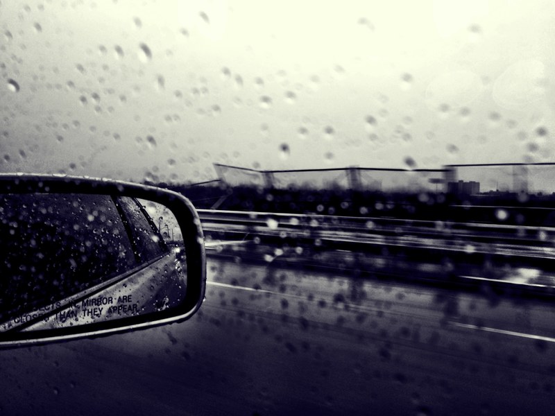 black and white shot of car wing mirror and window reflection with rain droplets and road, car mirror window reflection 4k