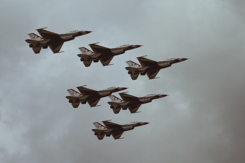 six fighter jets flying in a formation against a cloudy sky, usaf thunderbirds fly by 4k