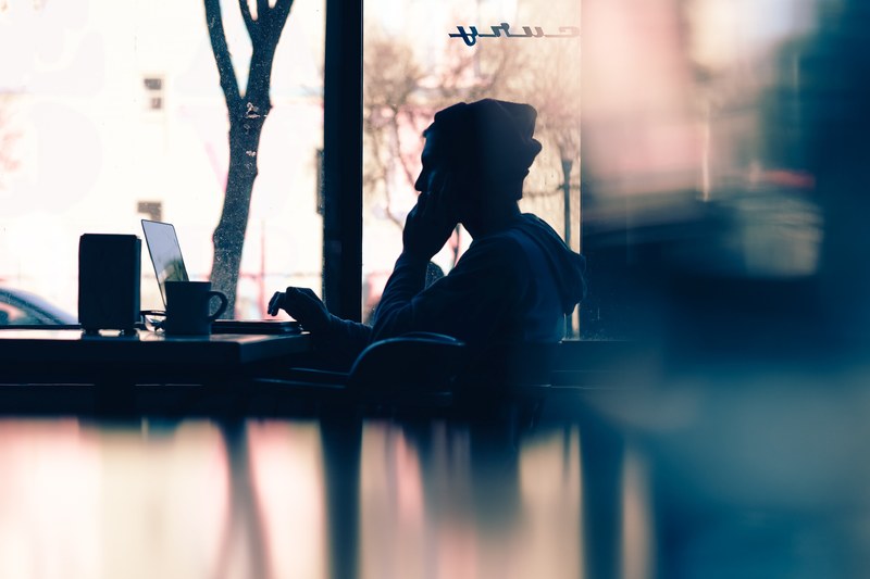 a man in a beanie working on a laptop in a coffee shop, good things come to those who hustle 4k