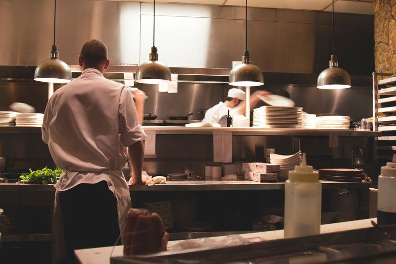 a chef preparing food in the kitchen of a restaurant, chefs at work 4k