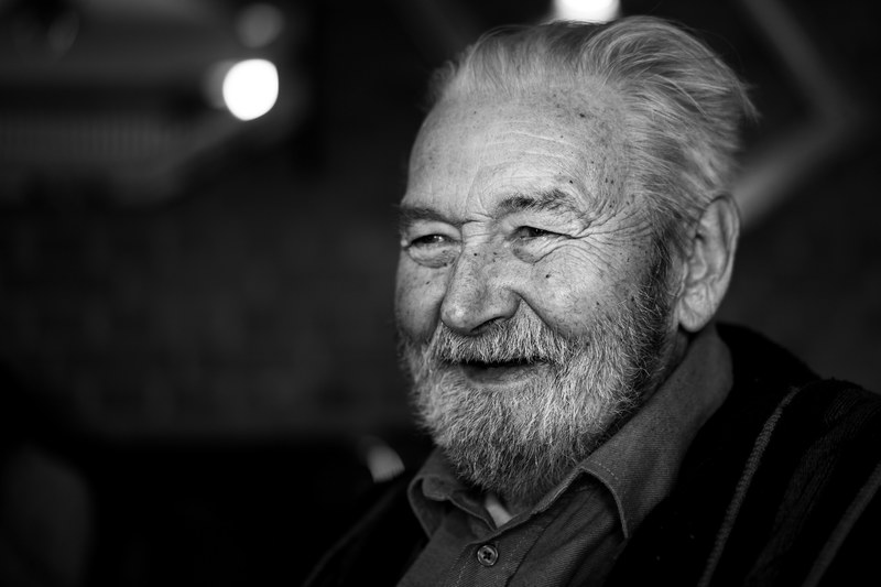 black and white shot of old man with beard and grey hair smiling, rest in peace 4k