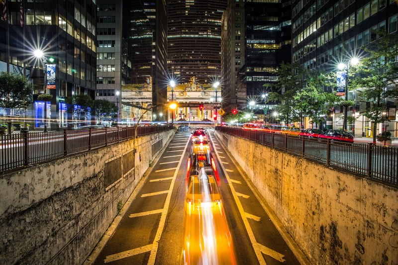 time lapse shot of new york city center street at night time surrounded by skyscrapers, new york city center street at night time 4k