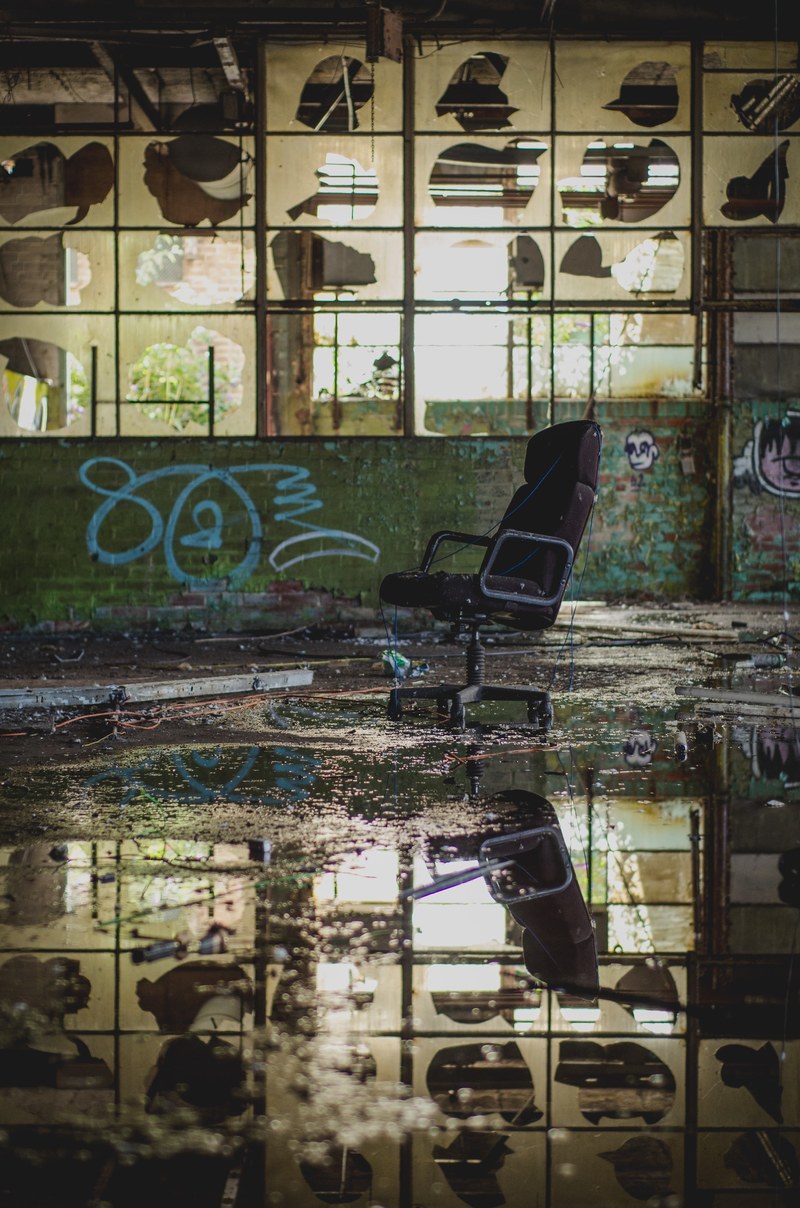 abandoned urban warehouse with chair and water reflection with graffiti tags on wall sheffield united kingdom, time to reflect_ 4k