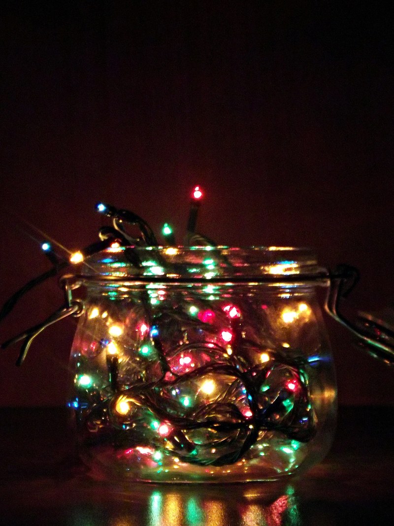 a glass jar containing christmas tree lights, _a jar full of lights 4k