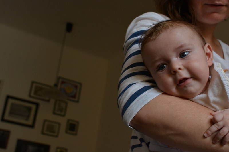a woman holding a baby in her arm, _baby in arms 4k