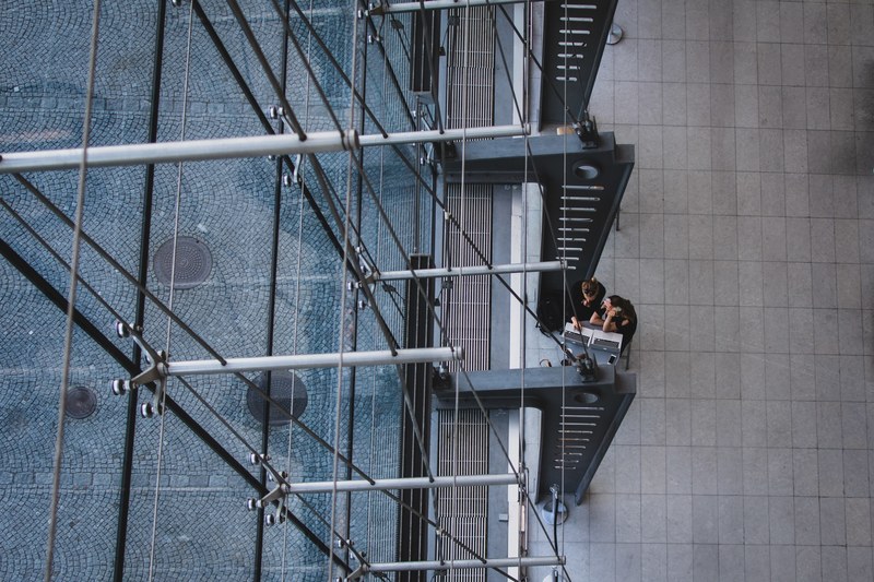 an overhead shot of two people working at laptops in the royal library, the break 4k