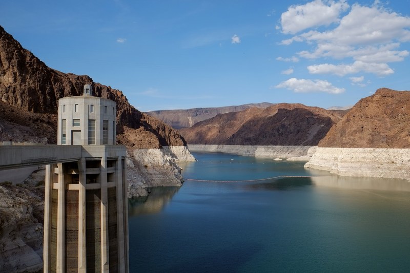 a large dam beside a river and rocky mountains, dam reservoir 4k