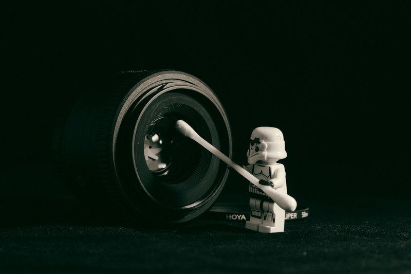 white toy stormtrooper figure with q tip cleaning black camera lens curitiba, cleaning bob 4k