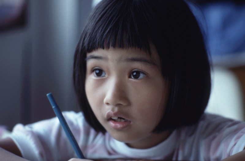 a child concentrating hard at school, child studying 4k