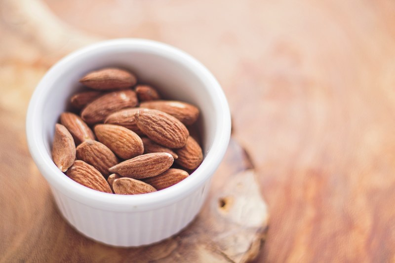 ramekin of raw almonds for a healthy snack, healthy almond snack 4k