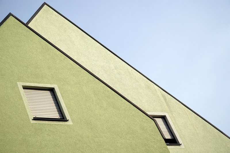 a green facade of a house with diamond shaped windows, green house facade 4k