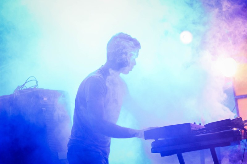 a man performing on a fog covered stage, _foggy stage dj 4k