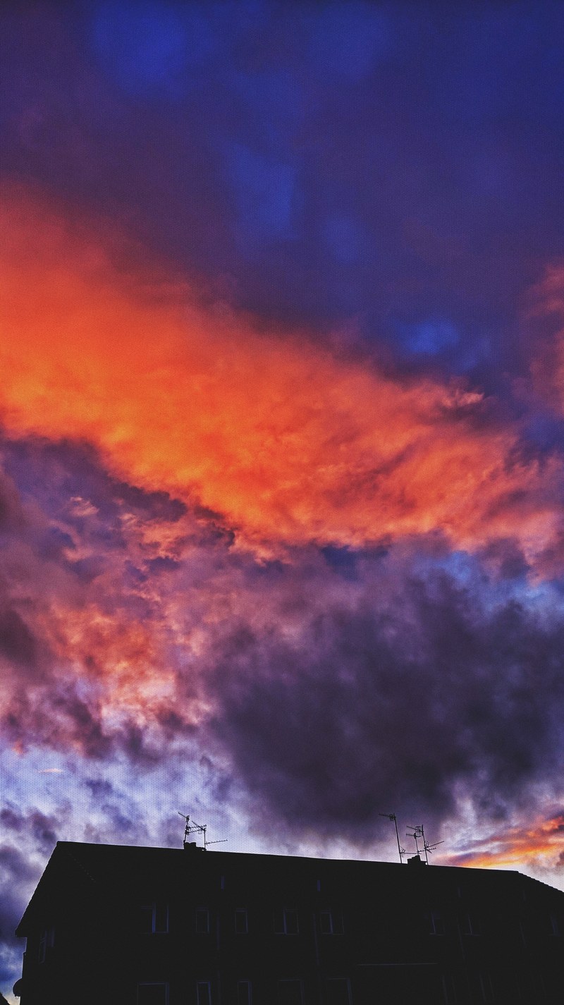 a red blue and purple clouded sky above a building, _red blue purple clouds 4k