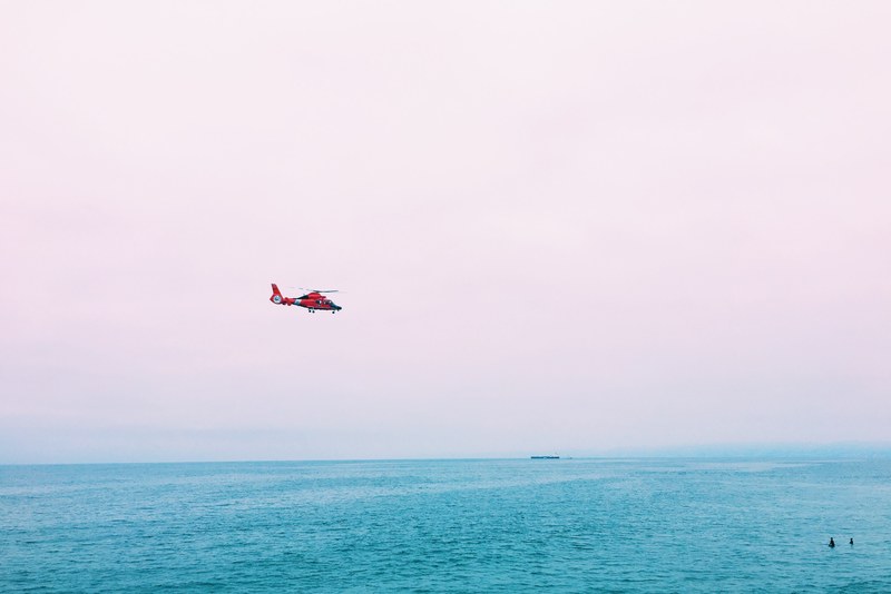 red rescue helicopter near the shore at manhattan beach pier manhattan beach california united states, coast guard over manhattan beach 4k