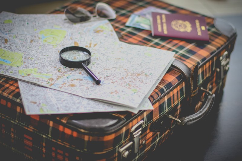 suitcase travel map and magnifying glass 4k