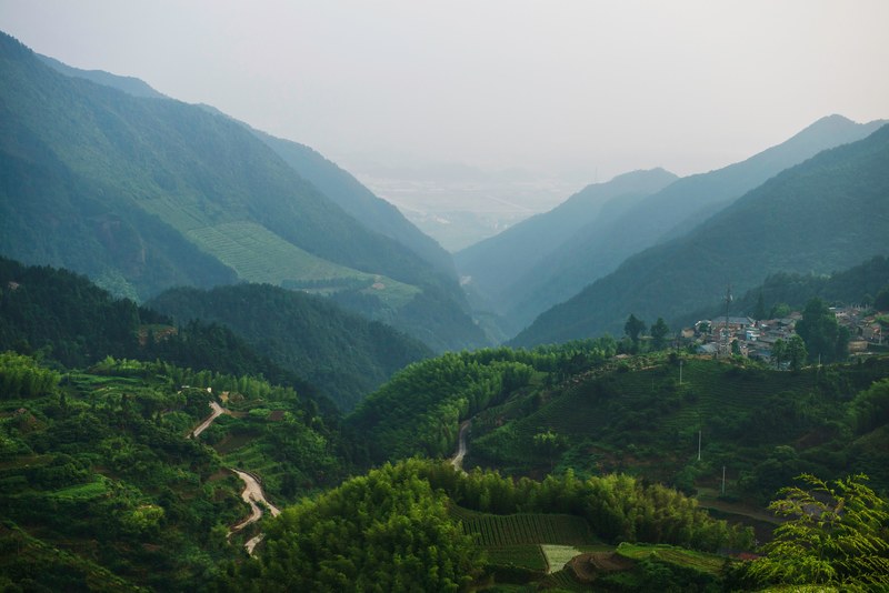 a village on a green hill overlooking a valley, village on green hills 4k