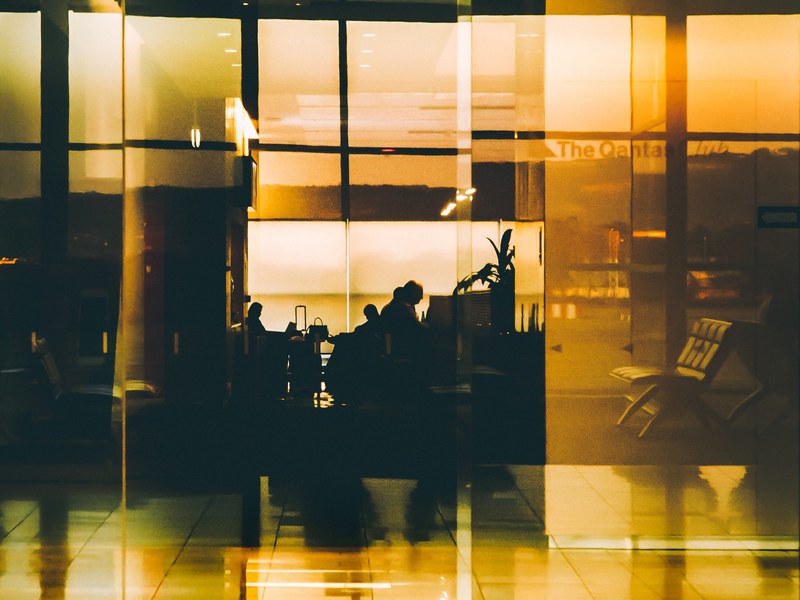 a fuzzy shot of silhouettes of people reflected in a glossy wall at the adelaide airport, airport reflection 4k