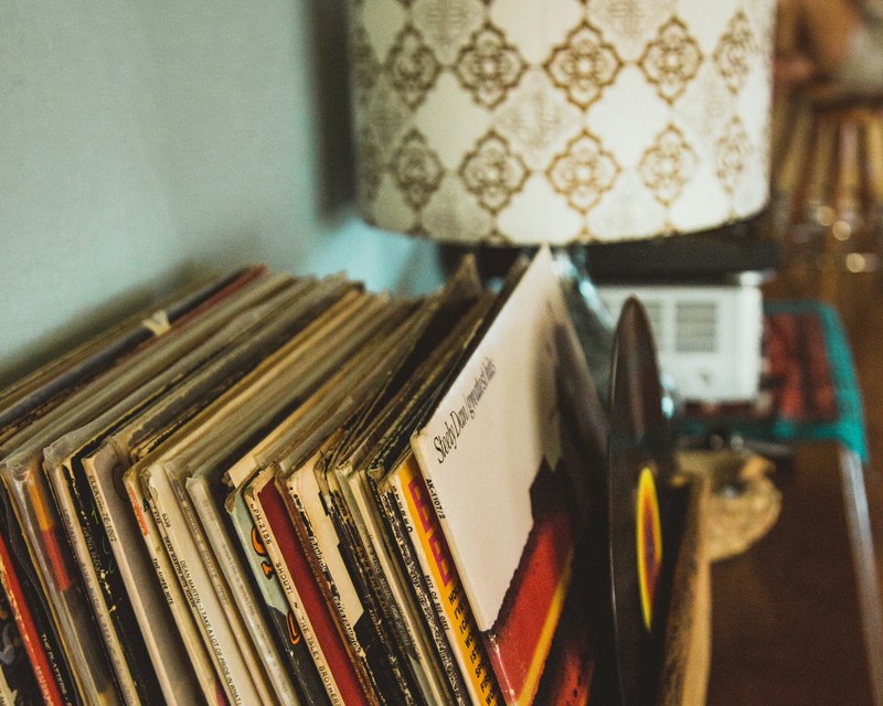 a collection of vintage records and a retro lamp, records in the desert 4k