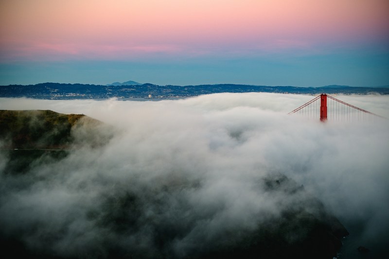 densely foggy sunrise showing the top of golden gate bridge from marin headlands, san francisco foggy sunrise 4k