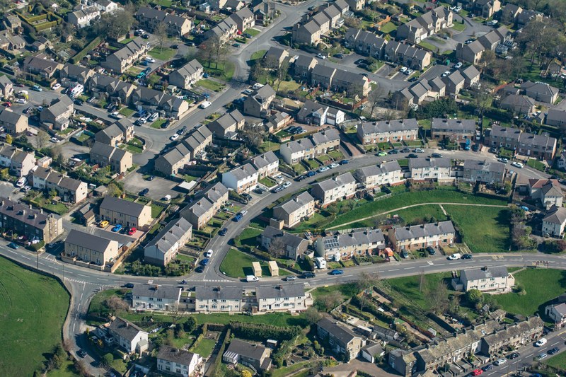 drone view of residential houses with cars parked along street, drone view of houses 4k